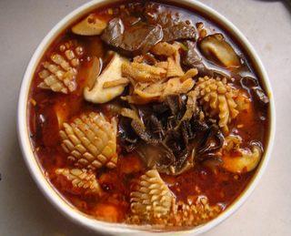 Mao Xue Wang (Sichuan Spicy Duck Blood Hot Pot) step 10: Bring everything back to a boil, then pour the cooked ingredients and broth into