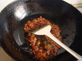 Mao Xue Wang (Sichuan Spicy Duck Blood Hot Pot) step 6: Heat a little oil in a wok over medium heat. Add the Pixian doubanjiang and stir