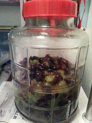 Homemade Grape Wine step 4: Crush the grapes by hand and place the juice, skins, pulp, and seeds into a ster
