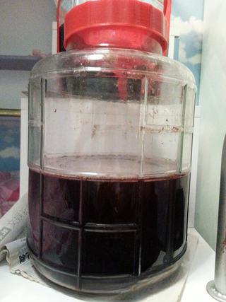 Homemade Grape Wine step 6: After approximately 20 days, strain out the solids. Transfer the liquid to a cle