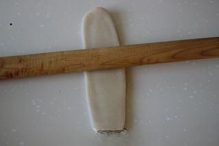 Savory Pork Pastries step 10: Rotate the dough and roll it out again into a long oval.