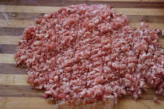 Savory Pork Pastries step 3: Prepare the pork filling by finely mincing the pork.
