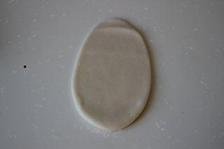 Savory Pork Pastries step 8: Place seam-side down and roll into an oval shape.
