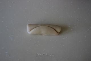 Savory Pork Pastries step 9: Roll the dough up tightly from top to bottom.