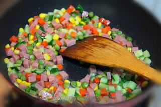 Thai Fried Rice with Vegetables and Seafood step 7: In the same wok, stir-fry the corn, peas, carrots, cucumber, and ham sausage wit