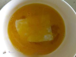 Pan-Fried Tofu with Egg and Bell Peppers step 6: Beat the egg with a pinch of salt, then dip each tofu slice into the egg mixture