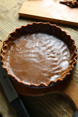 Cherry Chocolate Tart step 8: Roll out the chilled dough and fit it into a tart pan. Trim the edges neatly.