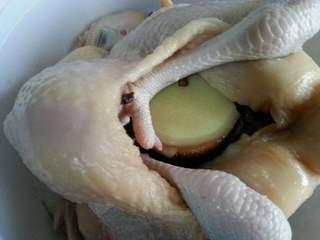 Five-Spice Roasted Chicken step 8: Stuff the cavity with ginger slices, scallions, and shiitake mushrooms.