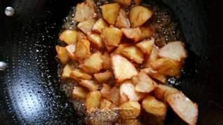 Candied Apple Fritters step 9: Add the fried apple pieces to the syrup and quickly toss until each piece is eve