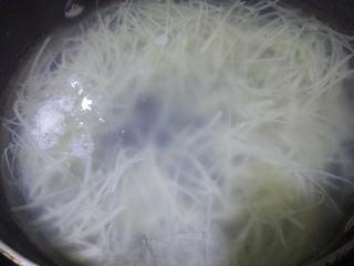 Stir-Fried Potatoes and Green Peppers step 6: Bring a pot of water to a boil. Blanch the potato strips until just tender, then