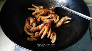 Braised Chicken Feet step 9: Pour in rice wine, light soy sauce, and dark soy sauce. Stir well.