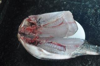 Baked Tilapia with Vegetables step 3: Clean the tilapia and cut it open along the backbone. Score the flesh several ti