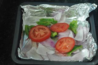Baked Tilapia with Vegetables step 5: Line a baking tray with aluminum foil and spread the cooked onion and bell peppe
