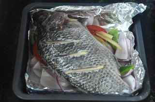 Baked Tilapia with Vegetables step 6: Place the fish on top of the vegetables. Insert ginger slices into the cuts and