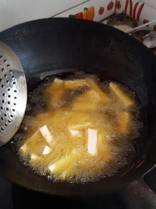 Candied Sweet Potato Fries step 3: Heat oil in a pan to medium-high heat, then add the sweet potato sticks.