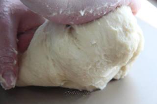 Soft Milk Sandwich Bread Recipe step 3: Transfer the dough to a work surface and knead until it becomes smooth and elast