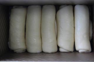 Soft Milk Sandwich Bread Recipe step 8: Place the shaped dough into a greased loaf pan and allow it to rise again until