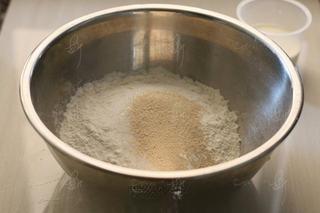 Steamed Milk Bread Rolls step 2: Combine the flour, sugar, and yeast in a mixing bowl.