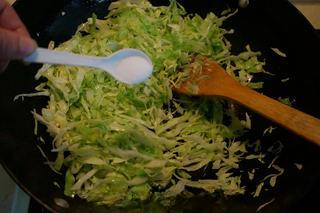 Stir-Fried Pancake Strips with Napa Cabbage step 7: Heat oil in a wok over high heat. Add the cabbage and stir-fry briefly, then sea