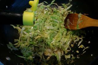 Stir-Fried Pancake Strips with Napa Cabbage step 8: Add soy sauce and continue stir-frying until the cabbage begins to soften.