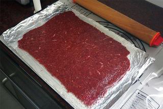 Spiced Beef Jerky Recipe step 3: Divide the mixture into two portions. Place each portion between sheets of parch