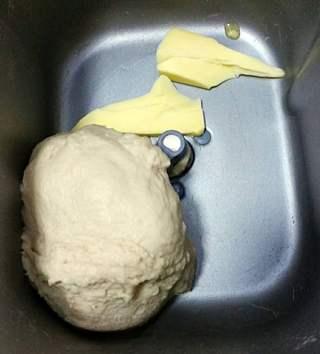 Sweet Red Bean Milk Bread Rolls Recipe step 2: Add softened butter and continue kneading until fully incorporated.