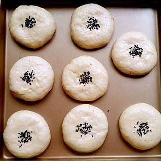 Sweet Red Bean Milk Bread Rolls Recipe step 7: Gently flatten each dough ball, sprinkle with black sesame seeds, and let rise a