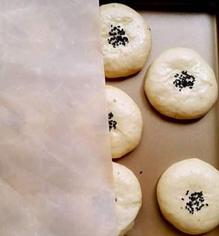 Sweet Red Bean Milk Bread Rolls Recipe step 8: Cover with parchment paper and place a second baking tray on top to keep the rol
