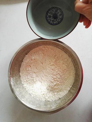 Whole Wheat Scallion Pancakes step 2: Gradually pour the hot water into the flour while stirring with chopsticks until