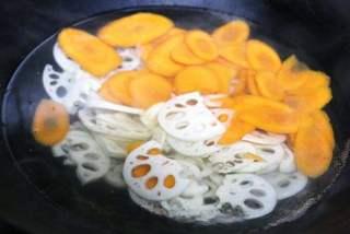 Quick Stir-Fried Mixed Vegetables step 2: Bring a pot of water to a boil. Blanch the carrot slices and lotus root for abou