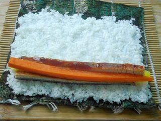 Grilled Eel Sushi Rolls step 3: Place a sheet of nori on a sushi mat or clean work surface. Spread an even layer