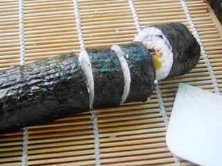 Grilled Eel Sushi Rolls step 6: Using a sharp knife moistened with water, slice the roll into bite-sized pieces 