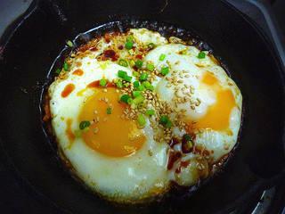 Aromatic Egg Pancake step 7: Remove from heat and sprinkle with white sesame seeds and chopped scallions.