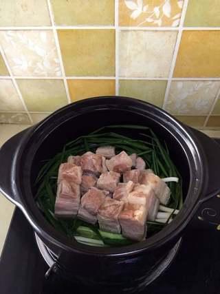 Clay Pot Braised Pork Belly Recipe step 5: Place the pork belly pieces skin-side down on top of the aromatics.