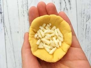 Cheese-Filled Sweet Potato Sesame Balls step 4: Divide the dough into portions of about 40g each. Flatten each piece, place abou