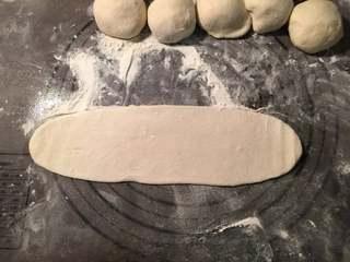 Pan-Fried Flatbread with Preserved Pork Recipe step 4: Roll each portion into a long strip.