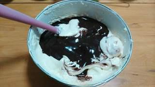 Black Forest Cake step 11: Fold the chocolate mixture and cherry liqueur into the batter.