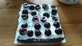 Black Forest Cake step 19: Brush the cake layers with cherry liqueur and spread with whipped cream and mari