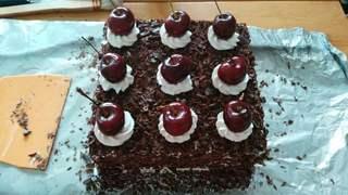 Black Forest Cake step 24: Pipe whipped cream rosettes and garnish with fresh cherries.