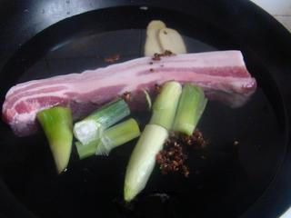 Steamed Pork Belly with Preserved Mustard Greens step 3: Place pork belly in a pot with cold water, scallions, ginger, and Sichuan pepper