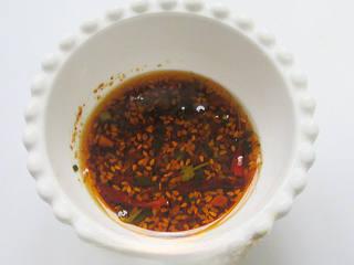 Pan-Fried Stinky Tofu step 4: Pour hot oil over the chili powder to create a simple chili oil. Stir in a littl