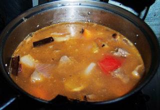 Tomato Braised Beef Brisket step 12: Pour in enough water to cover the beef. Add white pepper, sugar, salt, and white