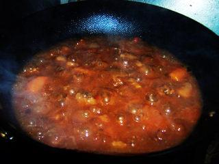Tomato Braised Beef Brisket step 13: Transfer to a wok or continue cooking uncovered. Add chicken bouillon and simmer