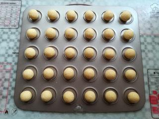 Coconut Custard Balls step 10: Roll each portion into a smooth ball and arrange on a lined baking sheet.