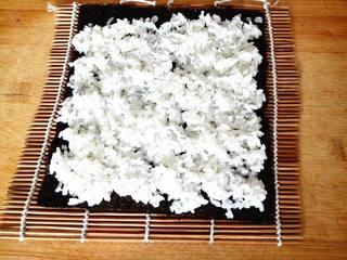 Ham and Cucumber Sushi Rolls step 5: Place a sheet of nori on a bamboo sushi mat and spread an even layer of seasoned