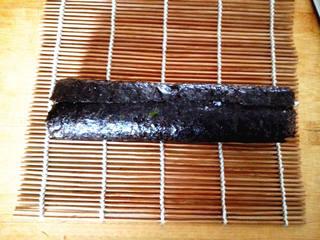 Ham and Cucumber Sushi Rolls step 7: Roll the sushi tightly using the bamboo mat, pressing gently to create a compact