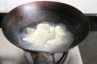 Lamb and Cabbage Dumplings Recipe step 11: Boil the dumplings until they float. Add a splash of cold water and return to a
