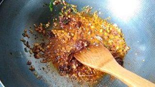 Spicy Hot Pot Noodle Soup step 5: Add the Pixian Doubanjiang and light soy sauce. Stir-fry until the seasonings ar