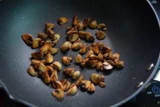 Roasted Enoki Mushroom Salad step 3: Heat olive oil in a skillet and cook the enoki mushrooms until lightly golden an