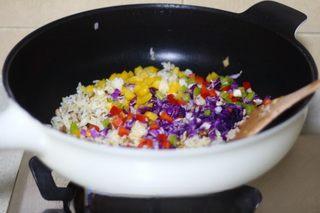 Omelette Fried Rice step 11: Add the bell peppers, red cabbage, and salt. Stir-fry until combined.